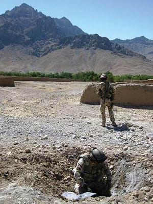 Weapons Intelligence Team conducting post blast exploration of IED blast site in Baluchi Valley, 9 September 2009.