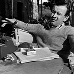 Paul Brickhill at his typewriter