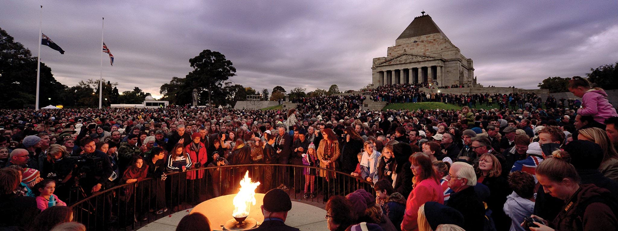 Crowds gather around the Eternal Flame at the Shrine of Remembrance Anzac Day Dawn Service