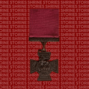 A Victoria Cross medal against a red backdrop with the words 'Shrine Stories' repeated over it. The medal has a red ribbon, and leaf detail on the top fascinator. The medal itself is a small cross with a crown and a lion, and the words 'For Valour' on it.