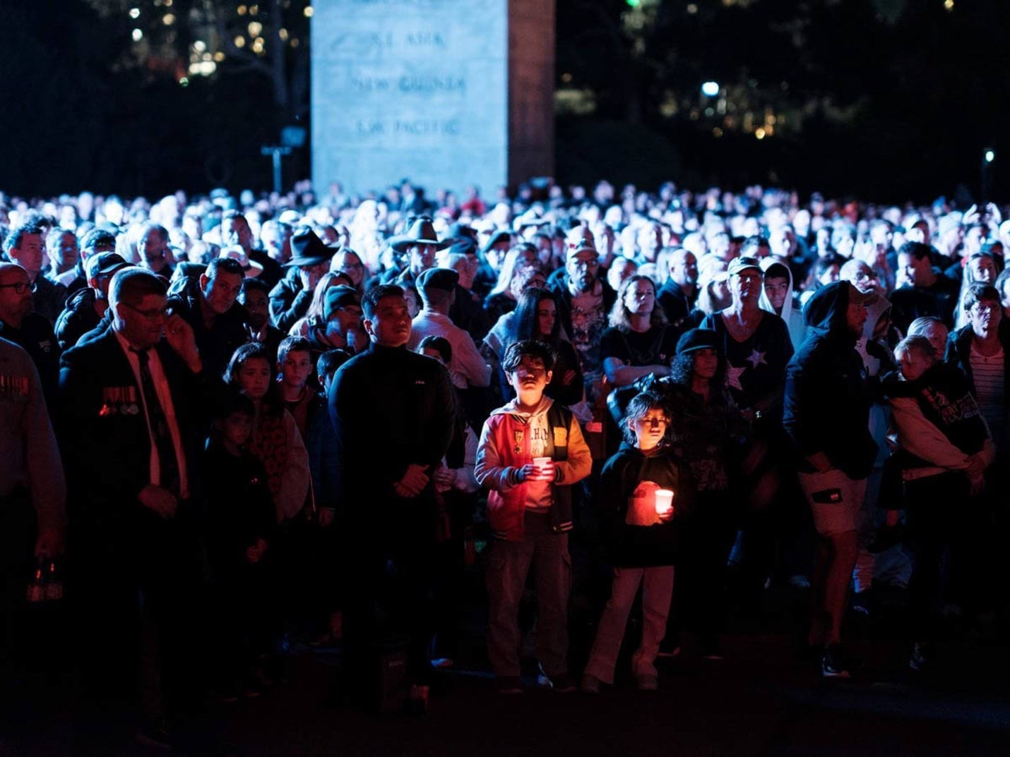 Children hold candles at the 2025 Dawn Service at the Shrine of Remembrance