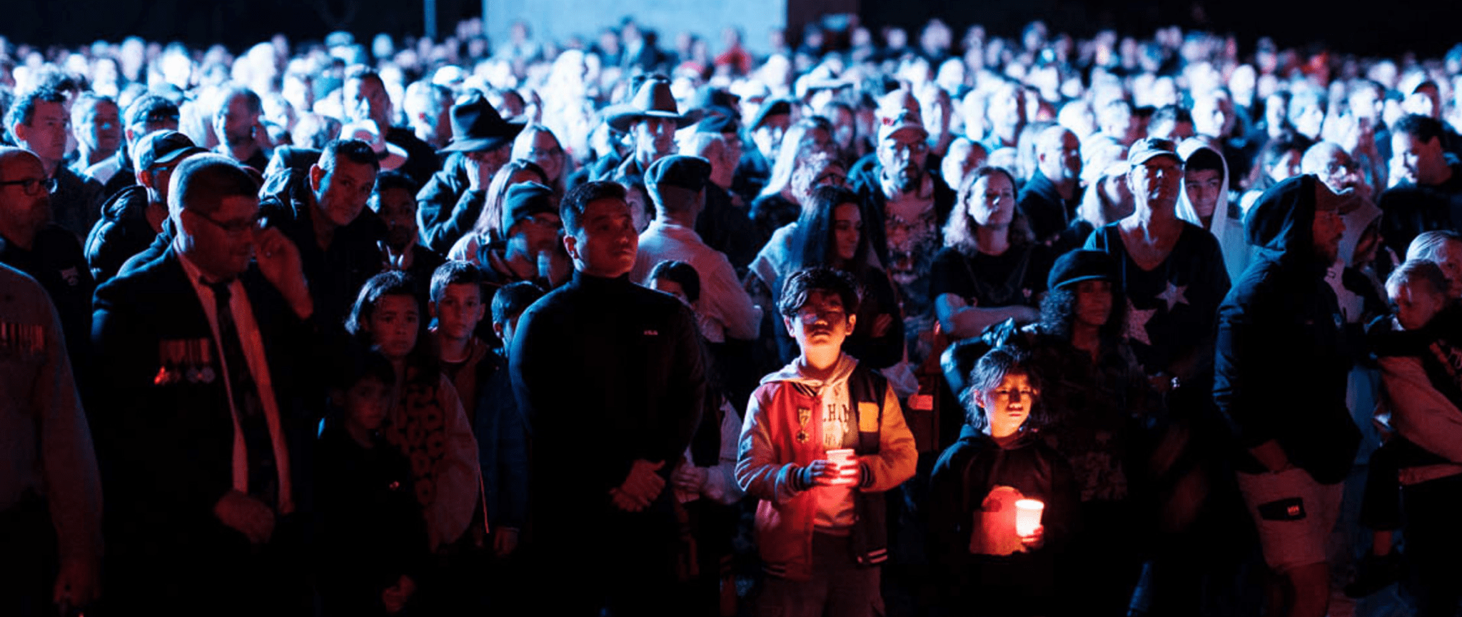 Young attendees hold a candle at the Shrine of Remembrance Anzac Day Dawn Service