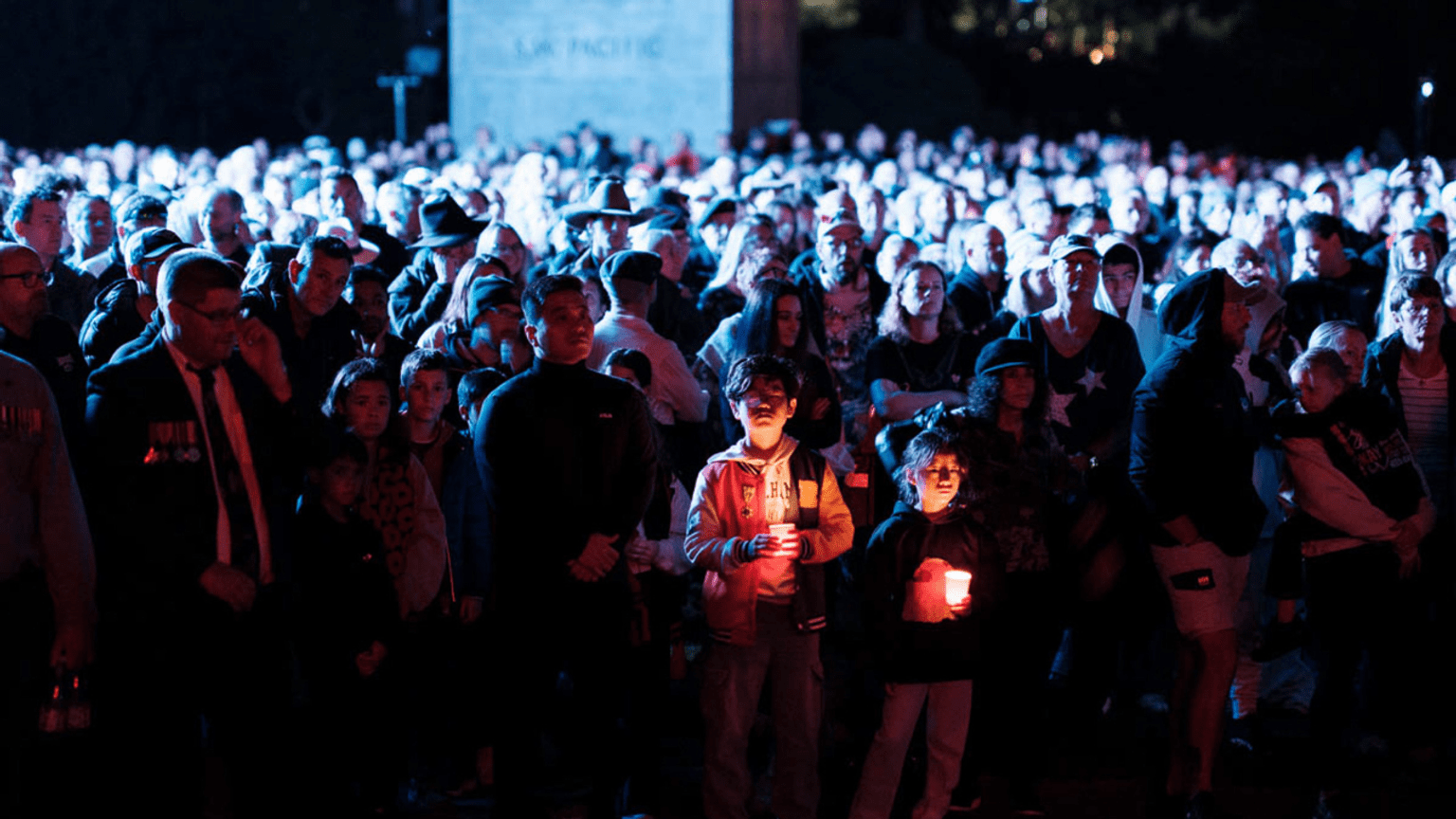 Young attendees hold a candle at the Shrine of Remembrance Anzac Day Dawn Service