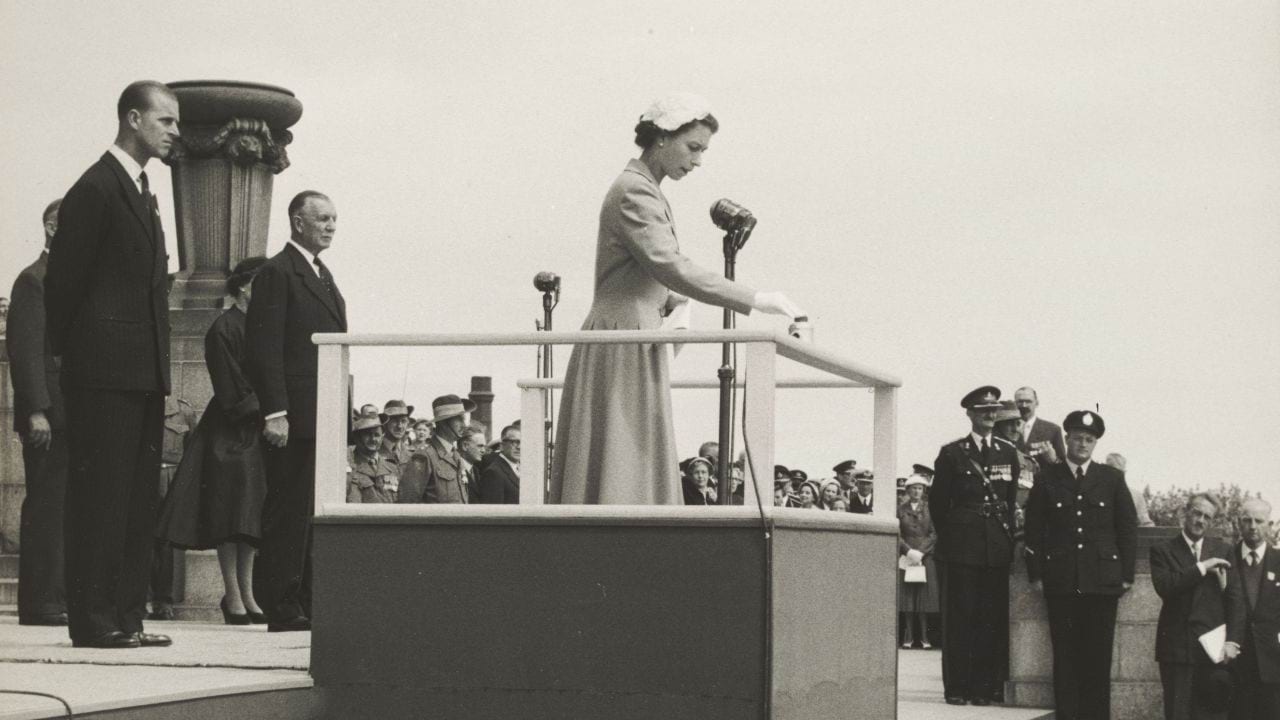 Her Majesty Queen Elizabeth II lighting the Eternal Flame at the dedication of the Shrine’s Second World War Memorial Forecourt