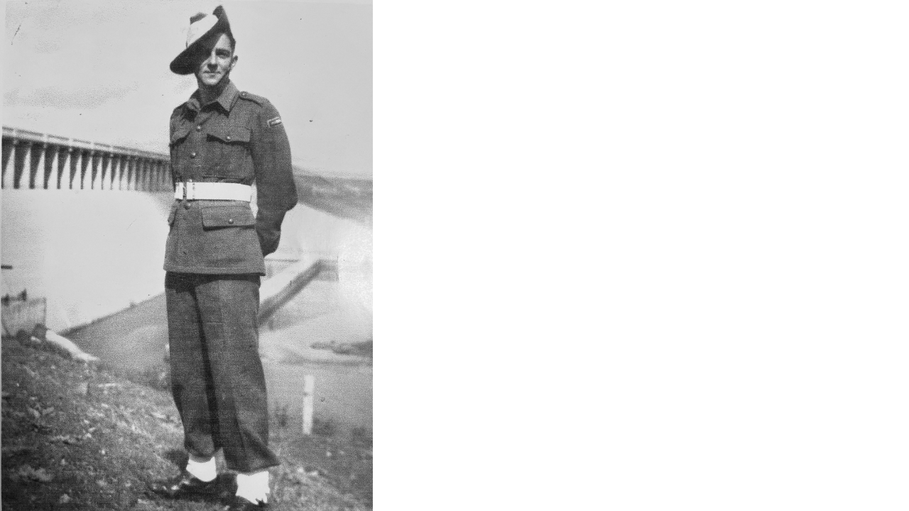 Black and white image of an 18 year old Alf Argent wearing his uniform in front of a weir whilst at training.
