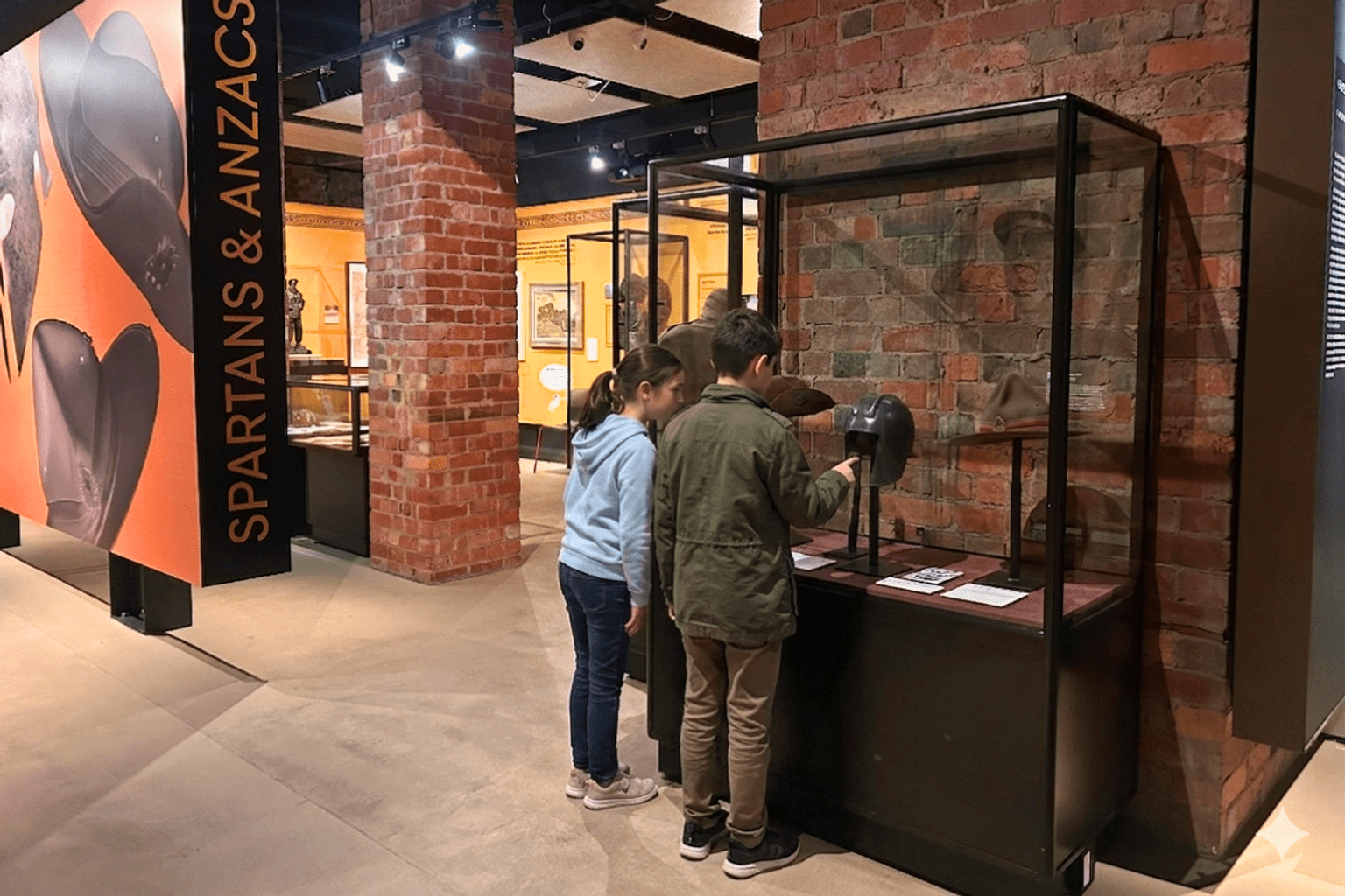 Two children looking at a display case in a muesum