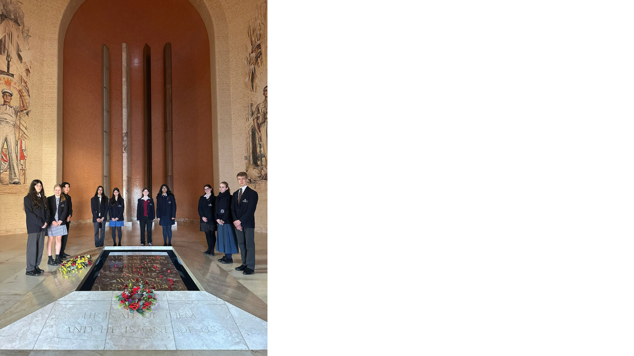Group photo of students at a war memorial